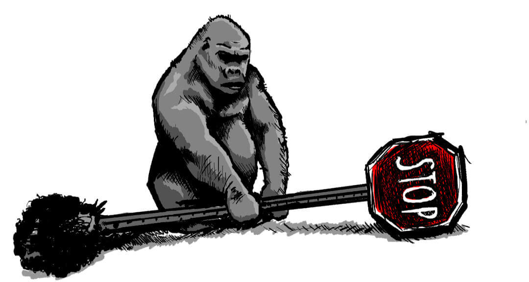 A giant gorilla holds an uprooted stop sign.